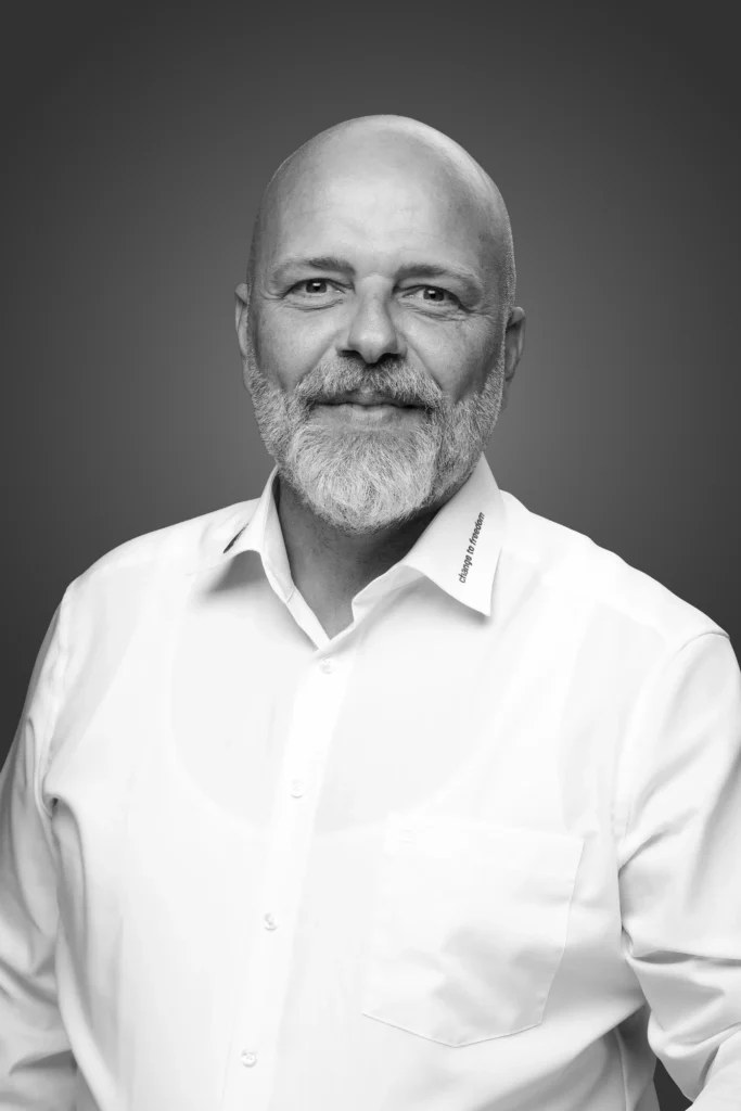 Man in white button-up shirt smiling