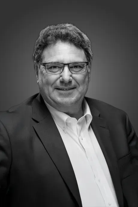 Smiling man in a suit and glasses