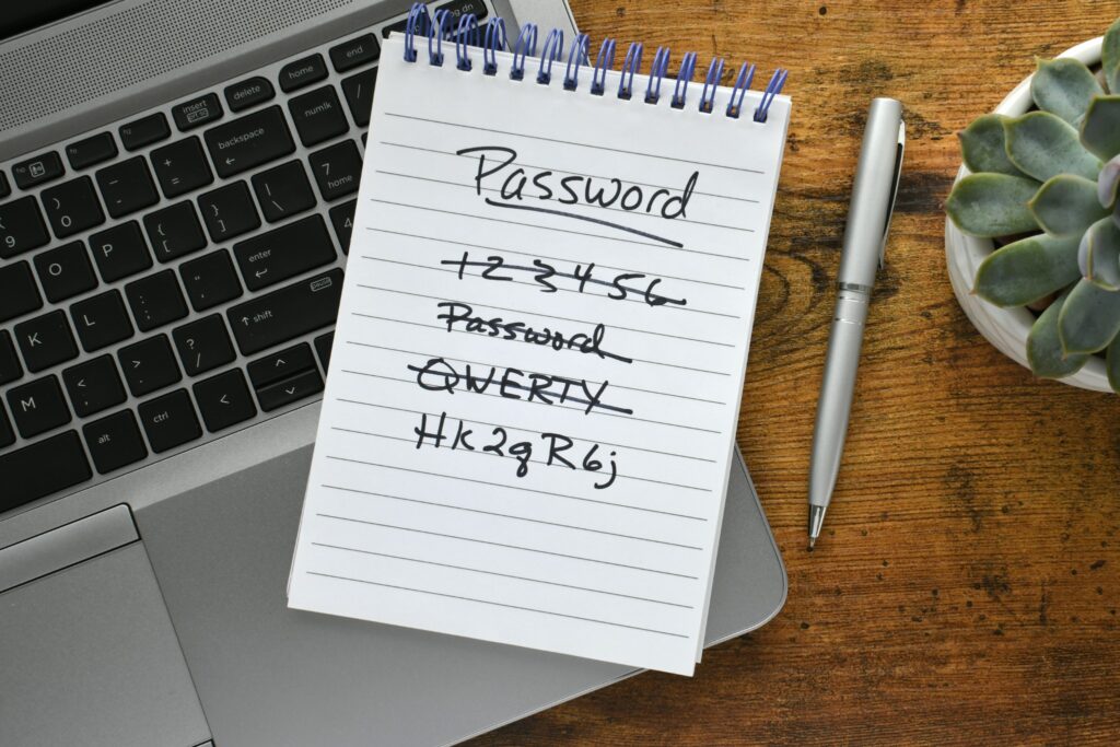 Notepad with password list on laptop.