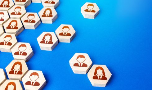 Wooden blocks with human icons on blue background.