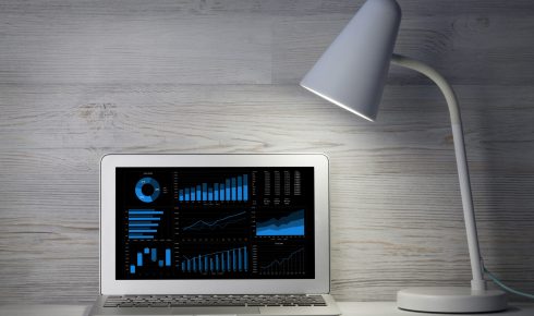 Home office workplace with blank black screen laptop computer. With copy space for your mockup or text
