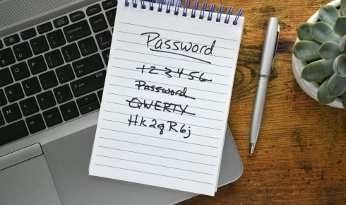 Notepad with password list on laptop.